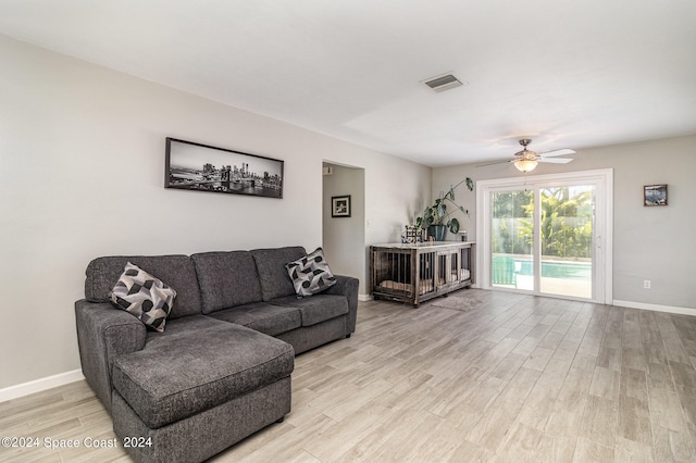 living room with ceiling fan and light wood-type flooring