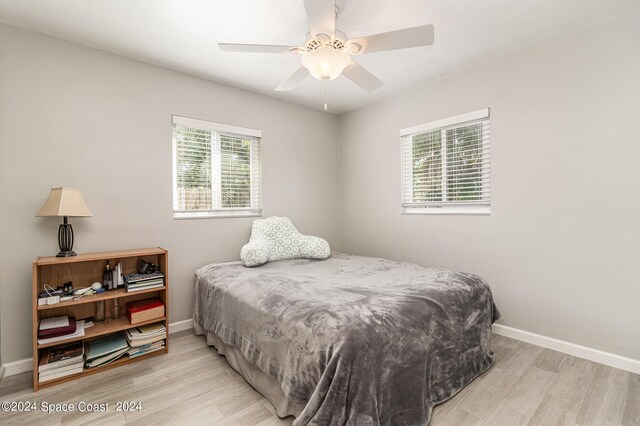 bedroom with ceiling fan and light hardwood / wood-style floors