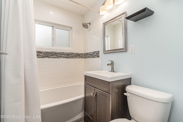 full bathroom with vanity, shower / bath combo with shower curtain, and toilet