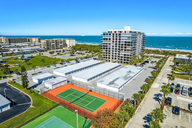 birds eye view of property featuring a water view and a beach view