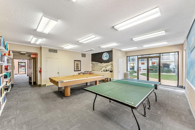 game room featuring a textured ceiling and dark carpet