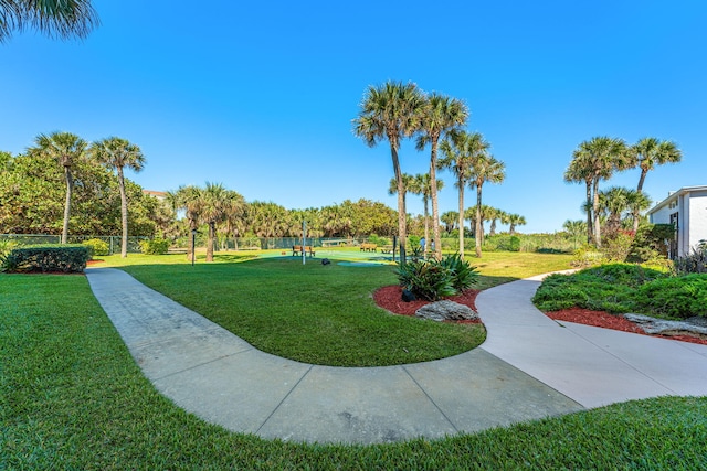 view of property's community with a lawn