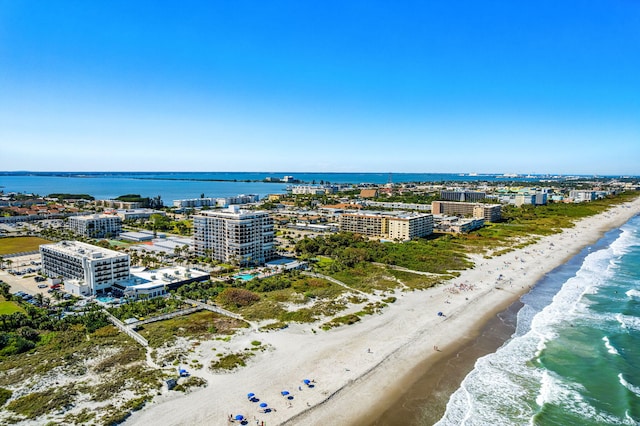 drone / aerial view with a water view and a beach view