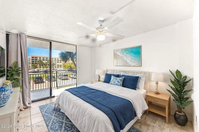 tiled bedroom with ceiling fan, a textured ceiling, and access to exterior