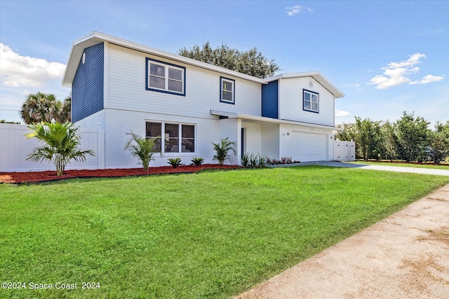 view of front of house featuring a garage, a front yard, fence, and driveway