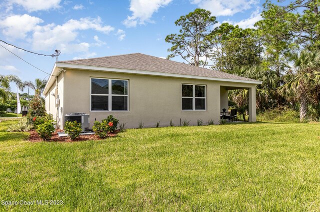 view of property exterior with cooling unit and a lawn