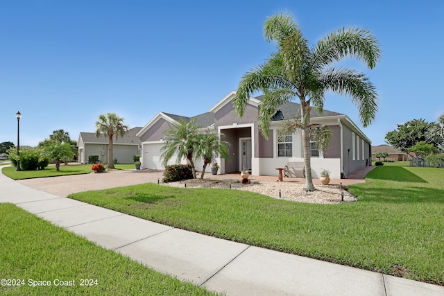 single story home with a front yard and a garage