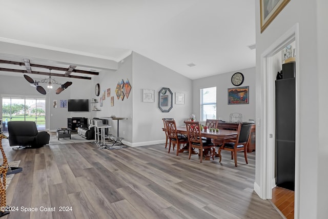 dining area with beam ceiling, light wood-type flooring, and a wealth of natural light