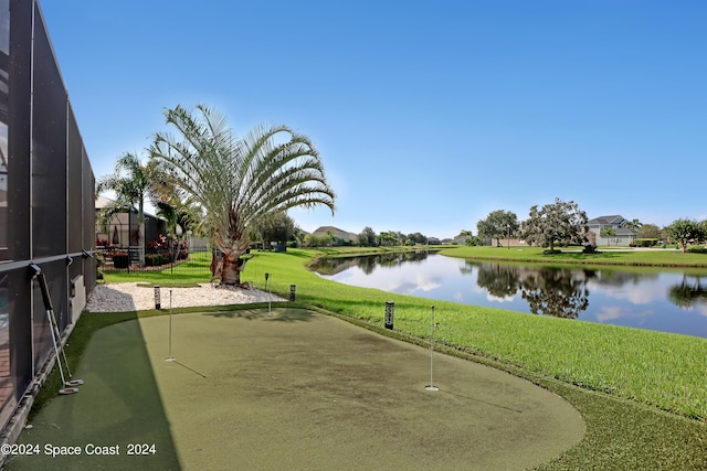 view of home's community with a lawn and a water view