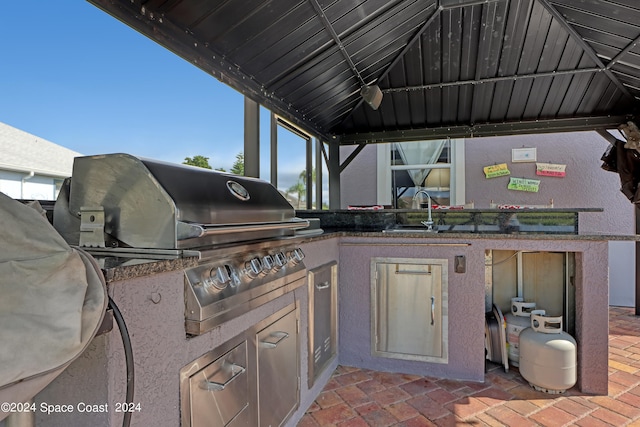 view of patio with a gazebo, area for grilling, and sink