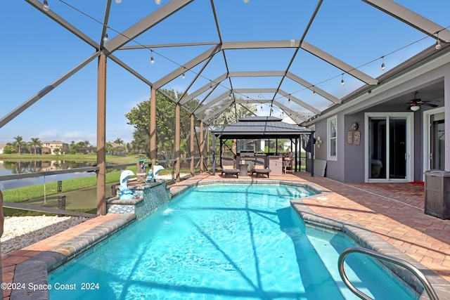 view of swimming pool with a water view, a gazebo, pool water feature, a lanai, and a patio