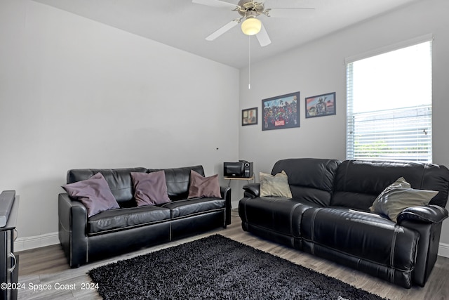 living room featuring ceiling fan and hardwood / wood-style floors