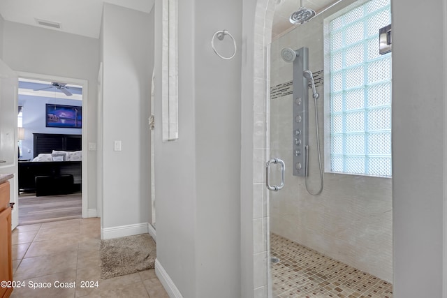 bathroom featuring tile patterned floors, ceiling fan, and an enclosed shower