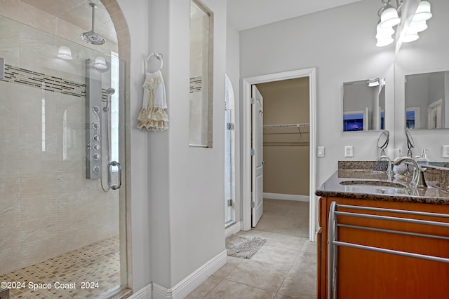 bathroom with tile patterned flooring, vanity, a chandelier, and an enclosed shower