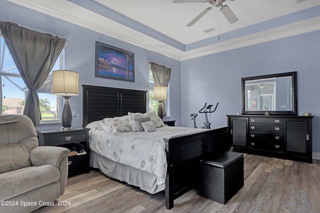 bedroom with hardwood / wood-style flooring, ceiling fan, and crown molding