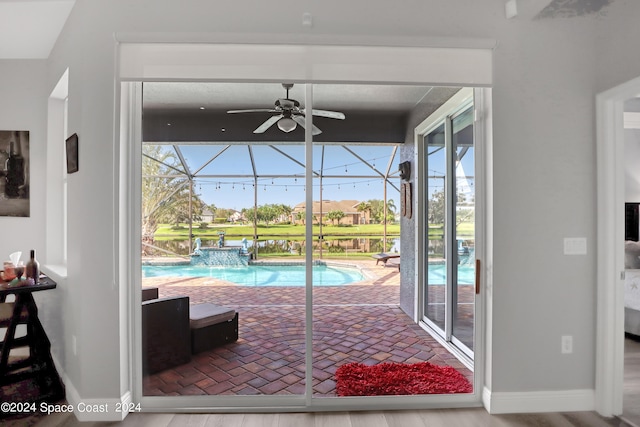 view of swimming pool featuring ceiling fan and pool water feature