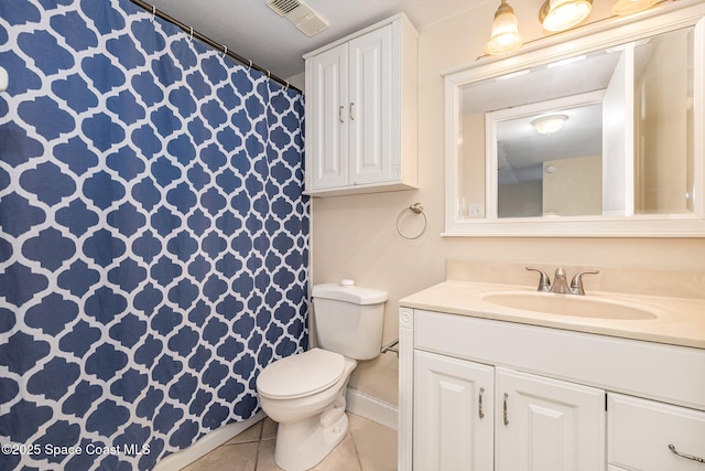 bathroom with toilet, tile patterned flooring, and vanity