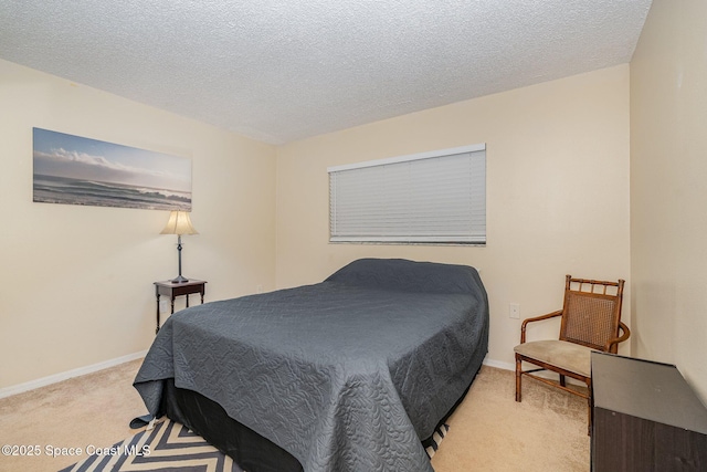 bedroom featuring light colored carpet and a textured ceiling