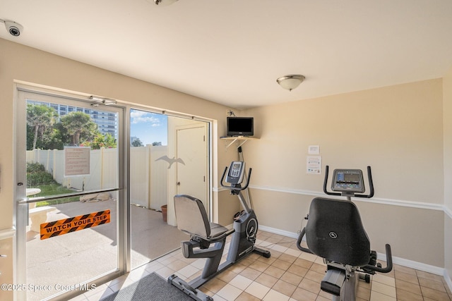 exercise room with light tile patterned floors