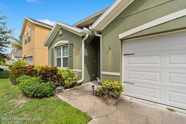 doorway to property featuring a garage