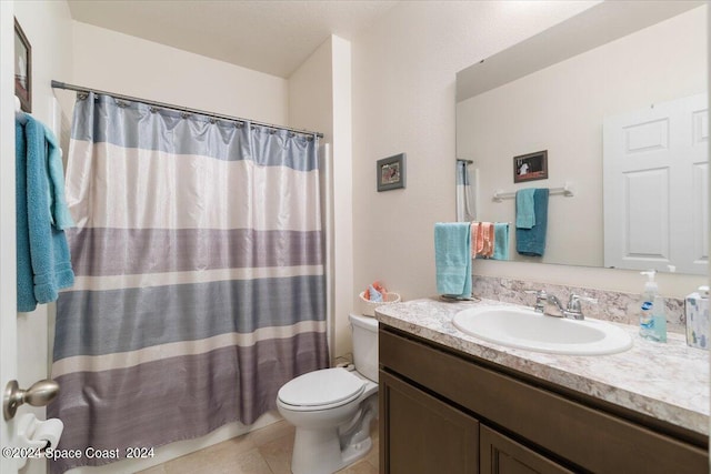 bathroom featuring vanity, toilet, curtained shower, and tile patterned floors