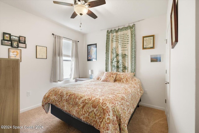 bedroom featuring ceiling fan and carpet