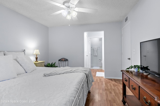 bedroom with a textured ceiling, ceiling fan, and light hardwood / wood-style flooring