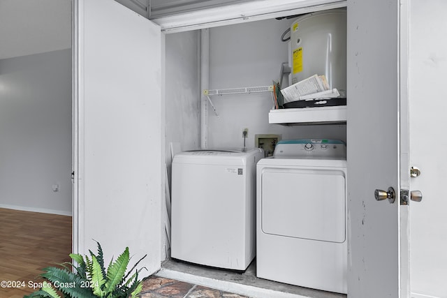 laundry area with light wood-type flooring and washing machine and dryer