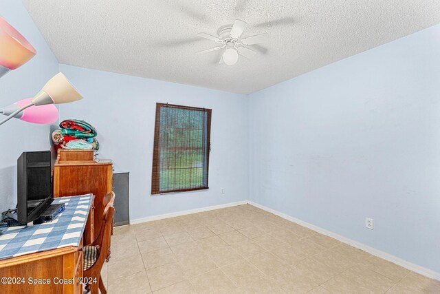 office space featuring a textured ceiling and ceiling fan