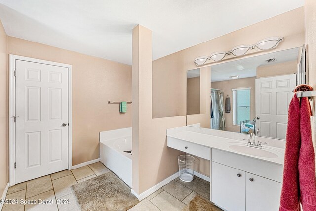 bathroom with tile patterned flooring, vanity, and shower with separate bathtub