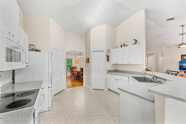 kitchen featuring white cabinets, white appliances, sink, kitchen peninsula, and ceiling fan