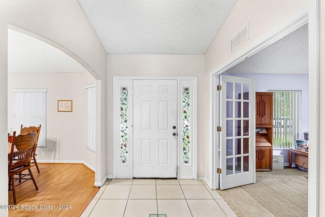 entrance foyer with a textured ceiling and light wood-type flooring