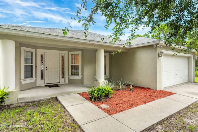 exterior space featuring a porch and a garage