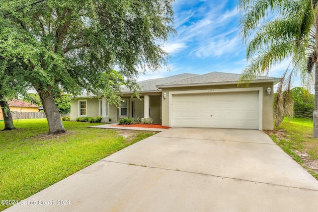 ranch-style home with a garage and a front lawn