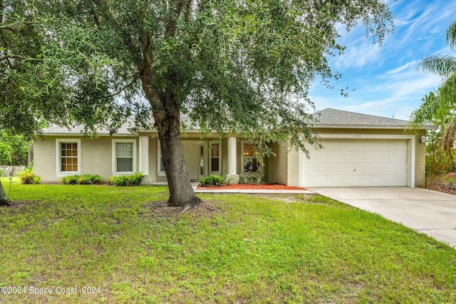 ranch-style home featuring a garage and a front lawn