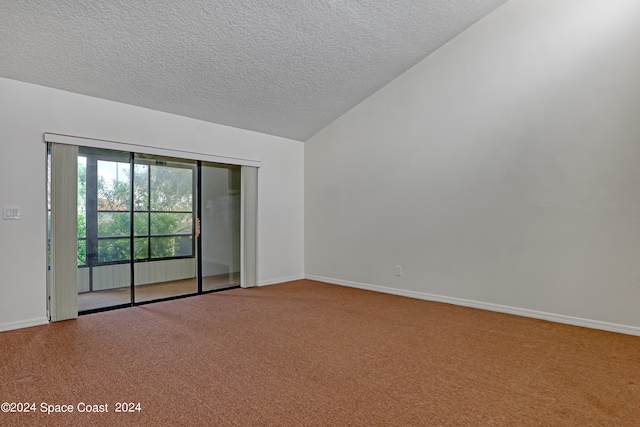 spare room with a textured ceiling, light carpet, and lofted ceiling