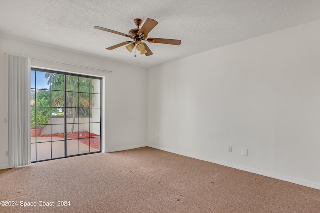 carpeted empty room featuring ceiling fan and a textured ceiling