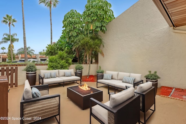 view of patio / terrace with an outdoor living space with a fire pit