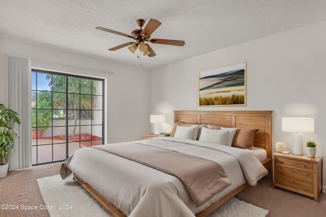 carpeted bedroom with a textured ceiling and ceiling fan