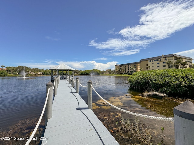 dock area with a gazebo and a water view