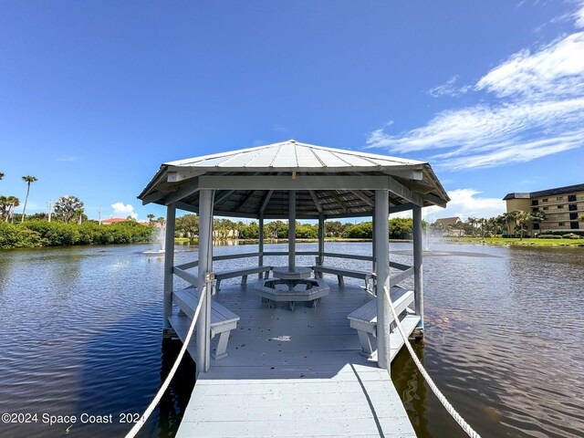 view of dock featuring a water view and a gazebo