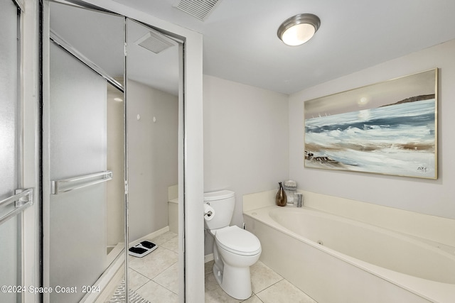 bathroom featuring a tub, toilet, and tile patterned floors