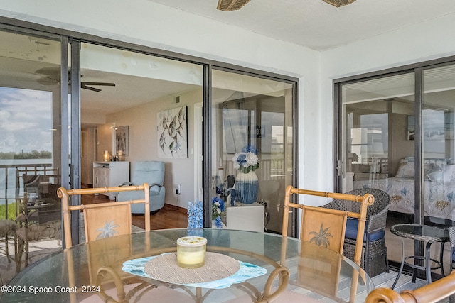 dining area with ceiling fan and hardwood / wood-style flooring