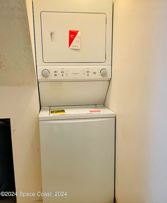 washroom with stacked washer / dryer