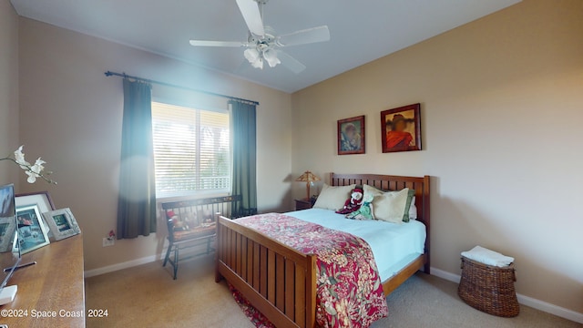 bedroom featuring light colored carpet and ceiling fan