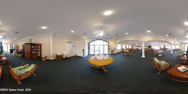 interior space with ornate columns, ceiling fan, carpet, and vaulted ceiling