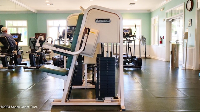 workout area featuring crown molding