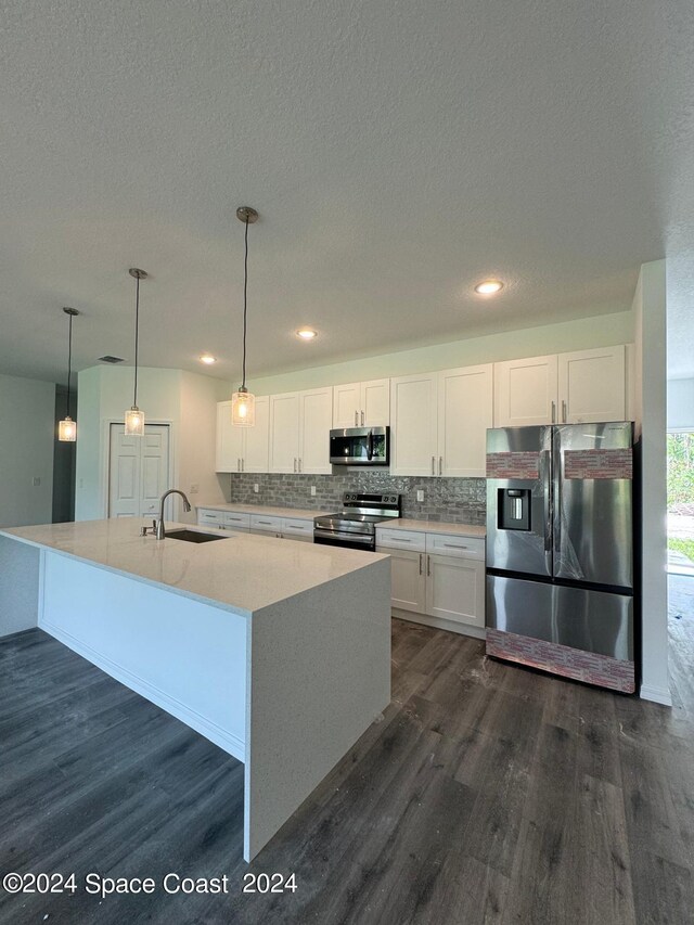 kitchen featuring dark hardwood / wood-style floors, appliances with stainless steel finishes, and white cabinets