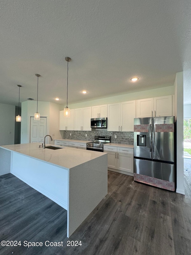 kitchen with a sink, white cabinetry, appliances with stainless steel finishes, and dark wood-style floors