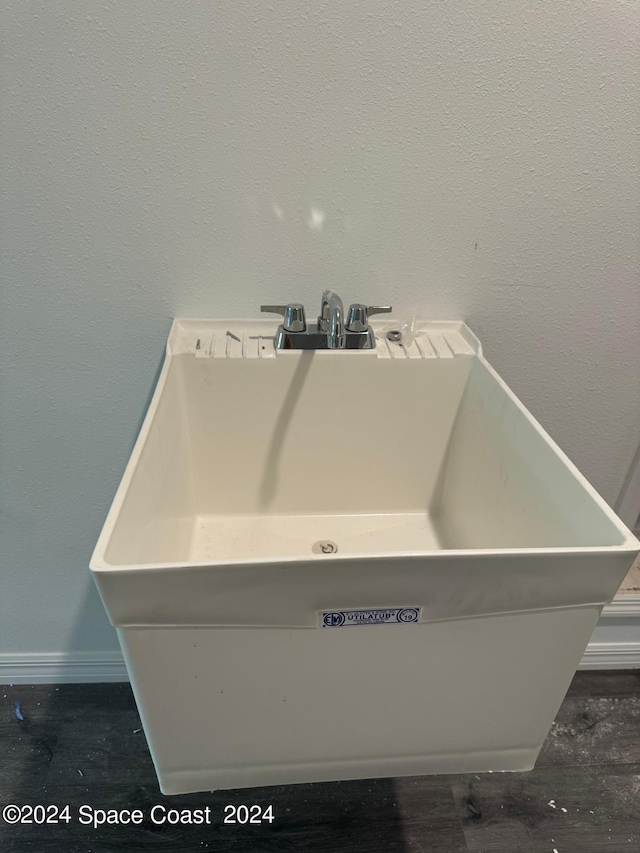 interior details featuring baseboards and a sink